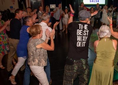 Many people learning to dance