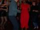Two people salsa dancing. Lady in a red dress